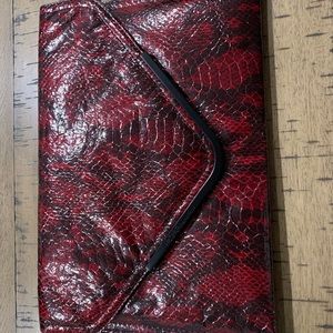 Red and black snake skin BCBG generation clutch